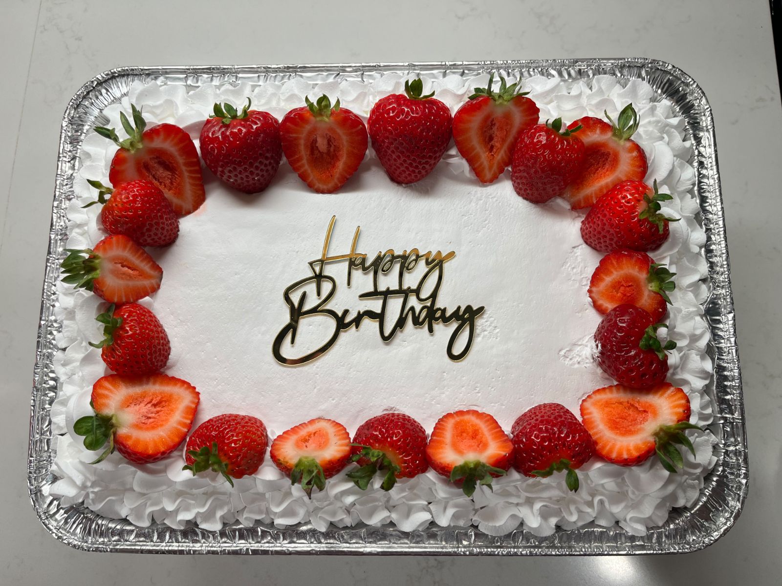 Rectangular tres leches bordered with fresh strawberries